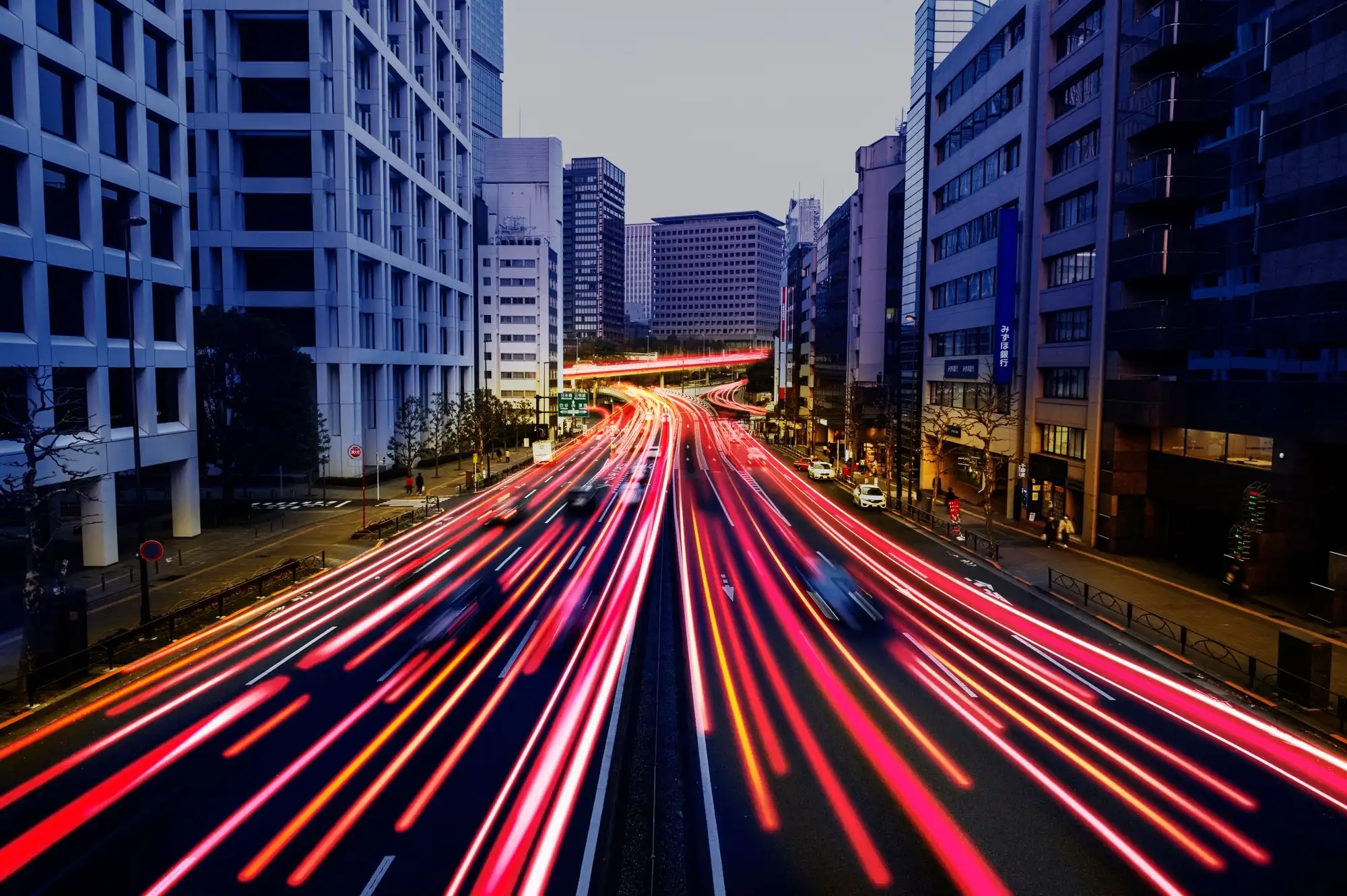 Fast-moving traffic lights on a city road at night